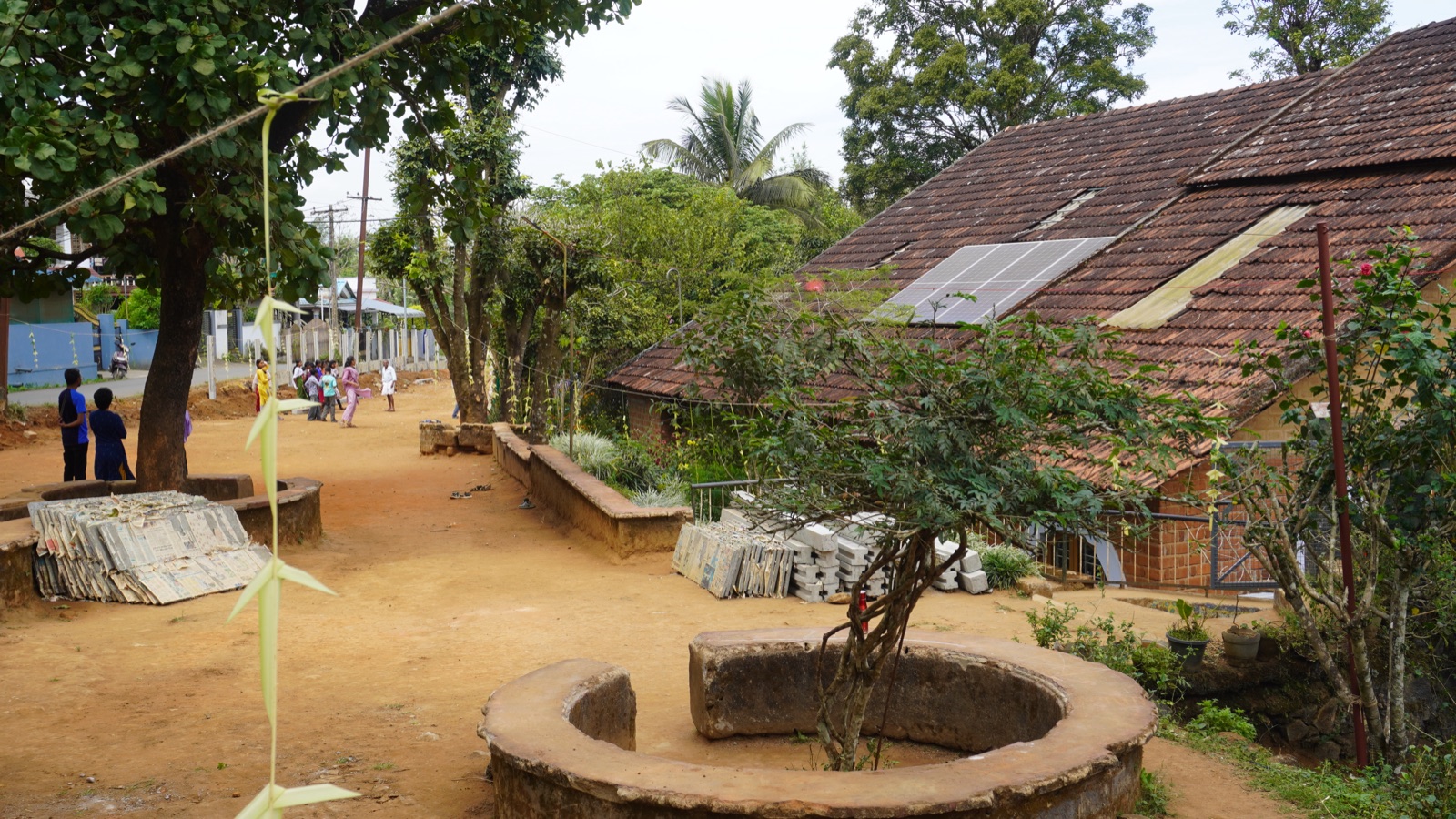 The Vidyodaya school grounds — tiled-roof buildings with solar panels, among trees