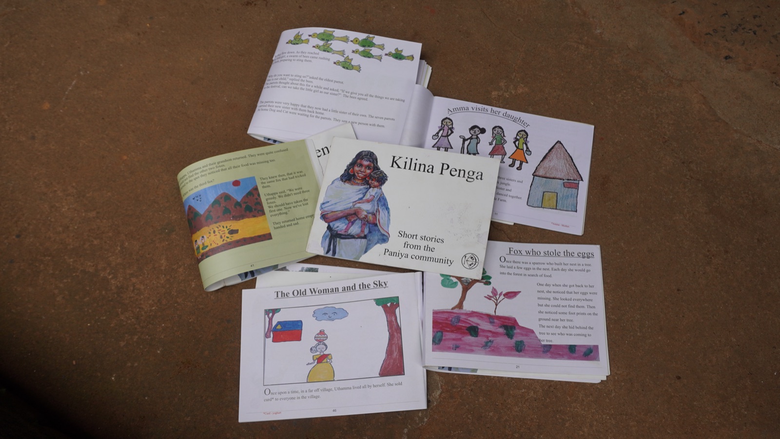 A stack of original short storybooks written by and with the Adivasi community